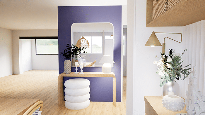 Aménagement d’entrée dans une maison à Cholet par ABL Intérieur avec une console en bois clair surplombée d'un miroir aux angles arrondis. Pouf blanc aux formes courbes. Mur bleu profond. Style transitionnel mixé avec un style bord de mer.