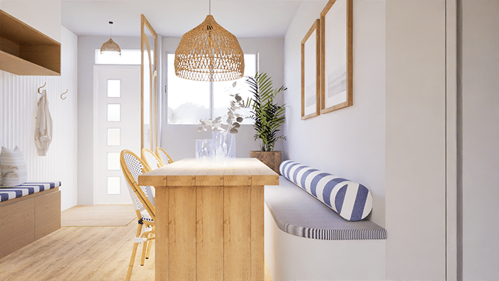 Aménagement d’une salle à mangée dans une maison à Cholet par ABL Intérieur avec une table massive en bois clair et trois chaise de bar. Une banquette sur-mesure blanche avec rangements à tiroirs et assise en tissus rayé bleu et blanc. Coussin arrondi rayé bleu et blanc. Plante verte. Style transitionnel mixé avec un style bord de mer.